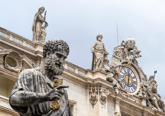 Fototapeta na wymiar Statue of St Peter outside St Peter's basilica in Vatican City with Clock Tower on background