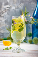 Detox cold lemonade with lime, mint and lemon zest, diet drink, healthy summer cocktail