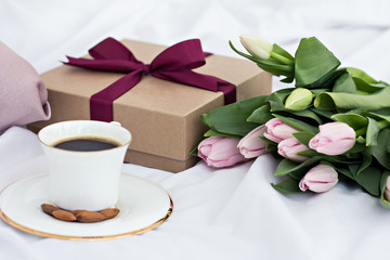 Bouquet of flowers - tulips, gift and coffee.