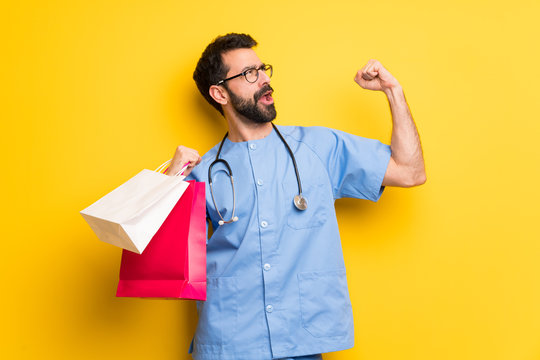 Surgeon Doctor Man Holding A Lot Of Shopping Bags In Victory Position