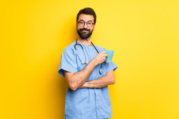 Surgeon doctor man holding a hot cup of coffee