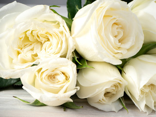 White roses on a white wooden table