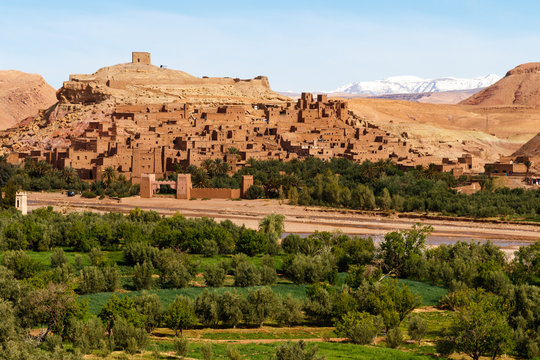 Fortified city along the former caravan route between the Sahara and Marrakech in Morocco with snow covered Atlas mountain range in background