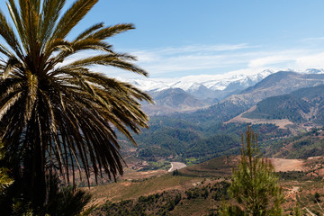 Fototapeta na wymiar Fortified city along the former caravan route between the Sahara and Marrakech in Morocco with snow covered Atlas mountain range in background