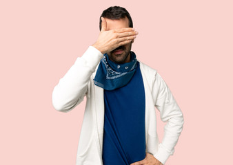 Handsome man with glasses covering eyes by hands. Do not want to see something on isolated pink...