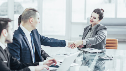 concept of partnership:a handshake of a Manager and a customer at the Desk in the office.