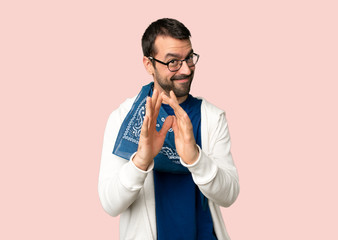 Handsome man with glasses scheming something on isolated pink background