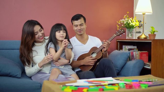 Portrait happy Asian family over red background