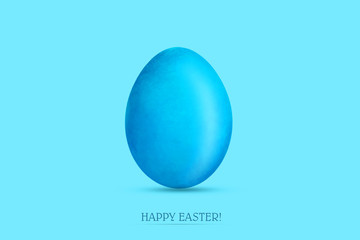 Blue easter egg on a blue background. Copy space. Easter.