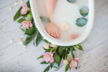 Obraz na płótnie Canvas Spa treatments. Healthy lifestyle. Little baby foot in the dairy bath. Health and beauty.