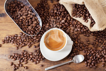 cup of coffee and coffee beans, top view