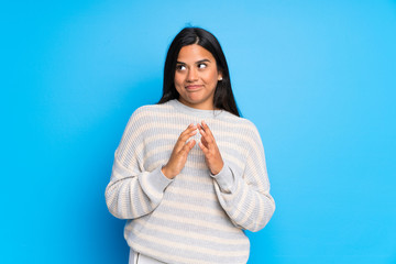 Young Colombian girl with sweater scheming something