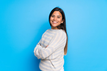 Fototapeta premium Young Colombian girl with sweater with arms crossed