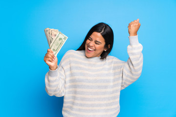Young Colombian girl with sweater taking a lot of money