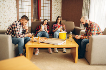 Sad friends drinks beer at the boring home party