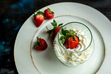 whipped cream with strawberries in a romantic glass