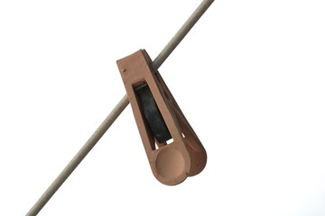 Plastic clothespin on rope isolated.