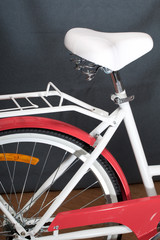Elements of a female bicycle in white and pink color.  Frame, pedals and wheel. Spring and summer recreation and sports.