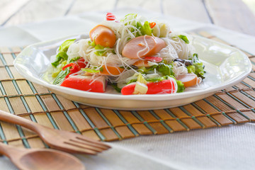 Spicy salad rice vermicelli with sausage, crab stick, green oak. healthy food concept 