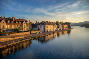 Fototapeta na wymiar Sunset on Yonne river, reflection of houses in the water, Burgundy, France