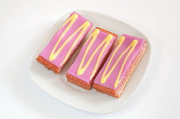 Slices cake topped with decorated purple fondant icing