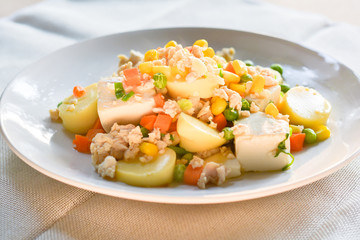 stir-fries egg tofu with minced chicken, pea, and carrot. Healthy food concept