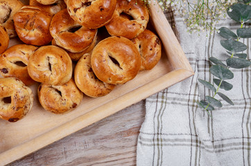 Freshly bun with raisins on a wooden table. Closeup.