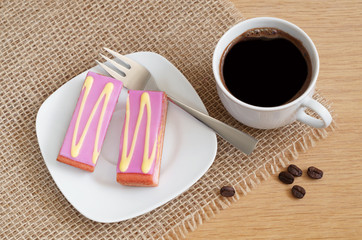 Coffee and cake with purple fondant icing