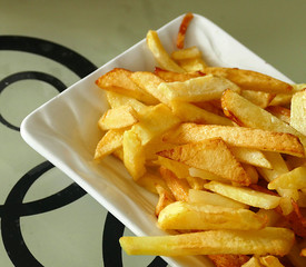 French fries in a plate on the table, close-up