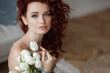 Very attractive young woman close up portrait. Beautiful female indoor. Curly haired lady. Red-haired girl. Redhead with wavy hair.