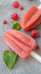 homemade juciy sorbet on a gray background whith fresh berries and mint. top view, flat lay