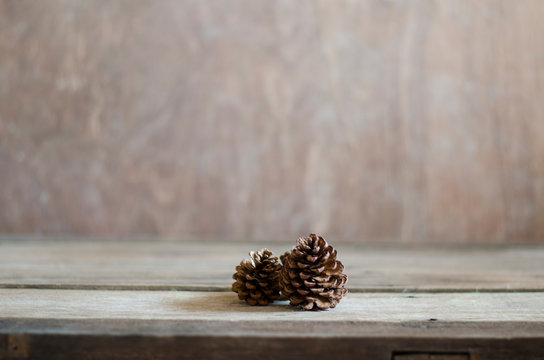 pine cones on wood background 