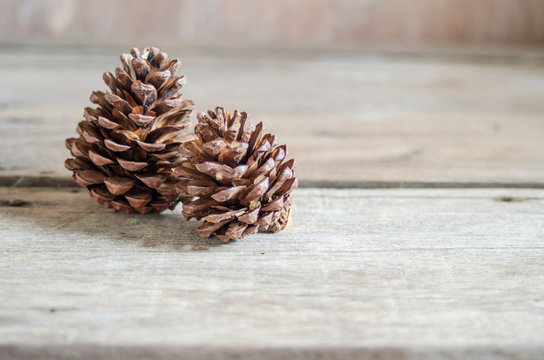 pine cones on wood background 