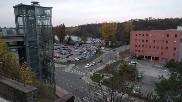 Timelapse of modern glass elevator in front of technical center Cesana on the background of sunset, Mlada Boleslav, Czech Republic