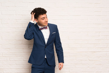 Man in suit and bow tie thinking an idea