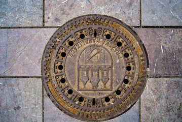 Traditional manhole cover for street hatchway in Prague. Czech republic