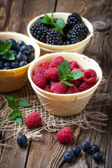 Blackberries, raspberries and blueberries in a waffle bowls.