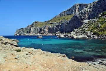 Sea bay with turquoise water, beach and mountains, Cala Figuera on Cap Formentor