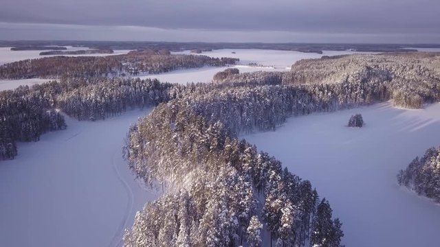 Bus driving on snowy ridge road in winter. Aerial shot.