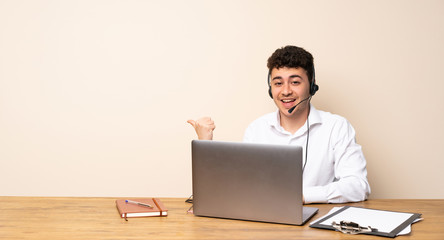 Telemarketer man pointing to the side to present a product