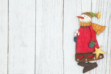 A snowman on weathered whitewash textured wood background