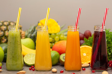 Assortment of fruit and vegetables smoothies in glass bottles. Fresh organic Smoothie ingredients. Detox, dieting or healthy food concept. Vegetarian food.