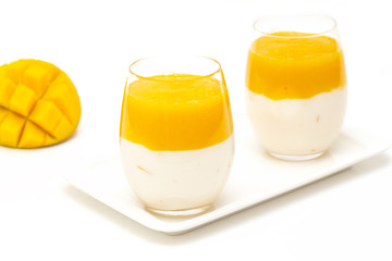 Fruit dessert with mango and mint over white background. Mango mousse. Italian dessert, homemade...