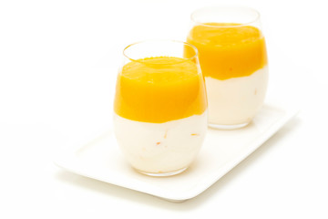Fruit dessert with mango and mint over white background. Mango mousse. Italian dessert, homemade cuisine. 