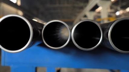 Metallic pipes on warehouse, rows of metal pipes on industrial warehouse. Industrial interior,