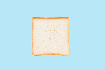 Single slice of toast bread isolated on blue background