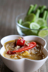 Herb Soya Beans with Minced Shrimp and Pork in Coconut Milk and chili in white bowl served with Fresh Vegetables, special recipe well decorate Thai tradition food sold in restaurant and market