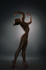 Graceful girl with gold bodyart profile shot