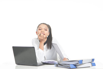 Office lady in white shirt and ponytail hair using a laptop and file