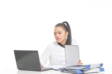 Office lady in white shirt and ponytail hair using a laptop and file